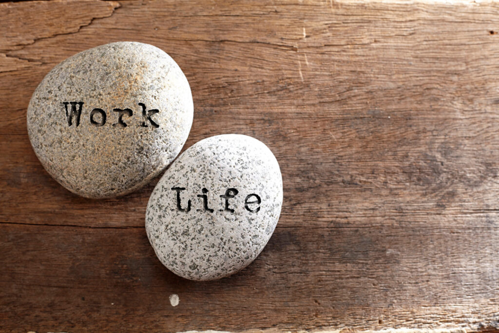 Two stones on wood reading Work and Life