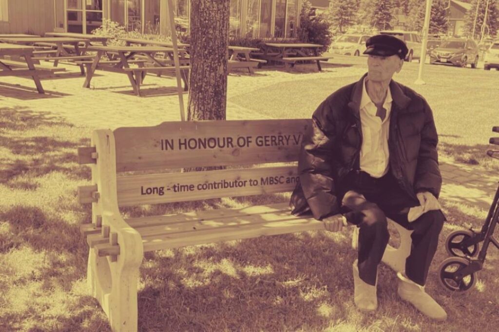 Gerry Van Klink sitting on bench dedicated in his honour
